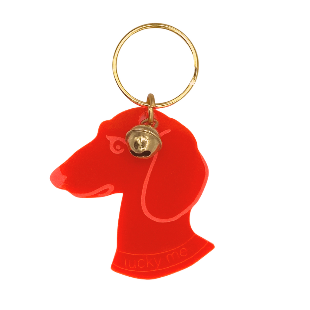 Schlüsselanhänger in form eines Dackel Kopfes in neon orange Acryglas 